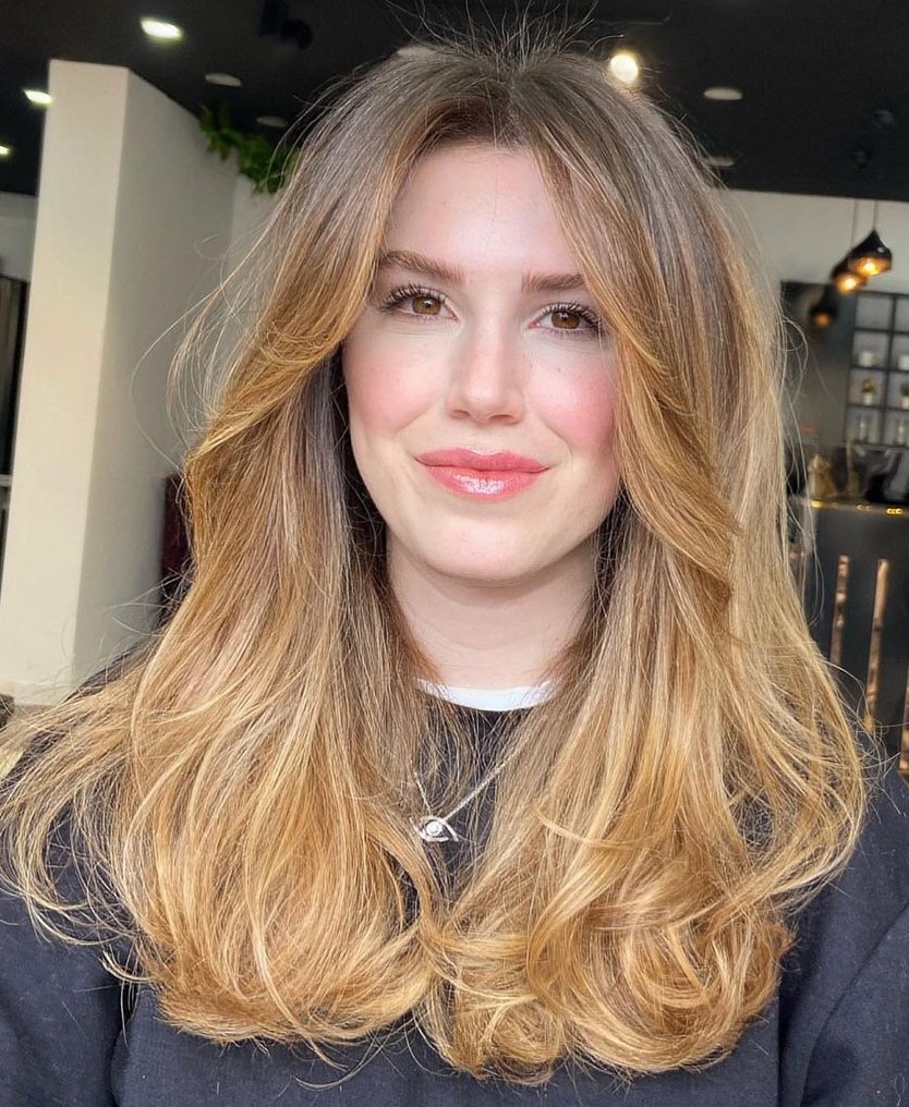 Long Layered Hair and Curtain Bangs with Ombre Feathered Layers and Light Strawberry Blonde Balayage