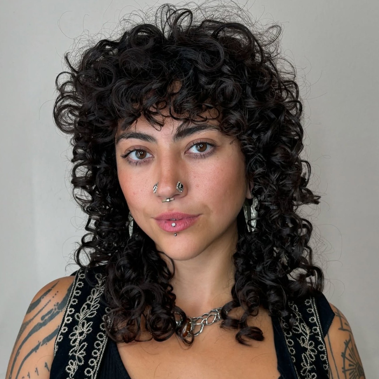 Long Curly Wolf Cut with Bangs